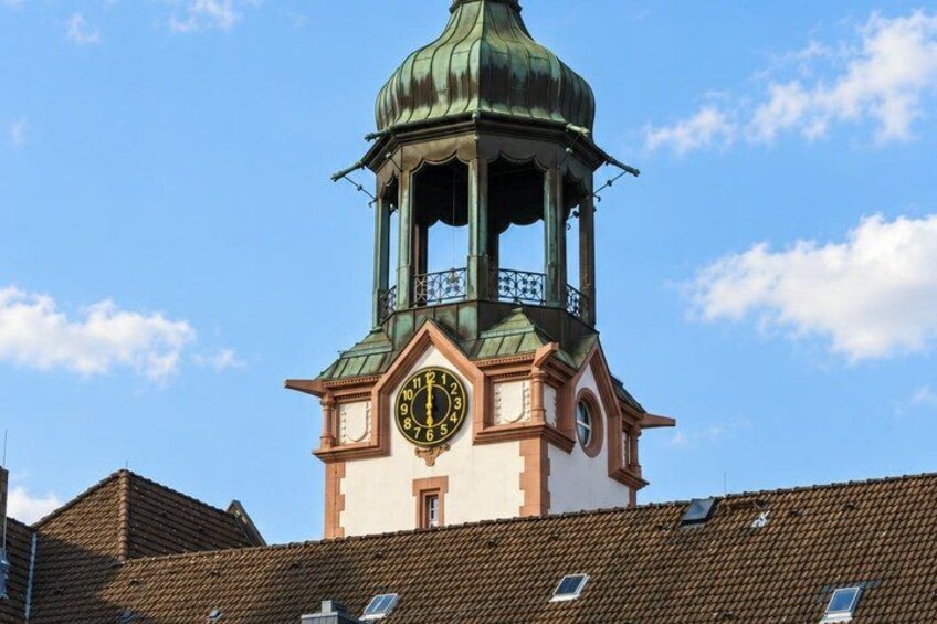 A clock tower with a green dome and a clock face. 4