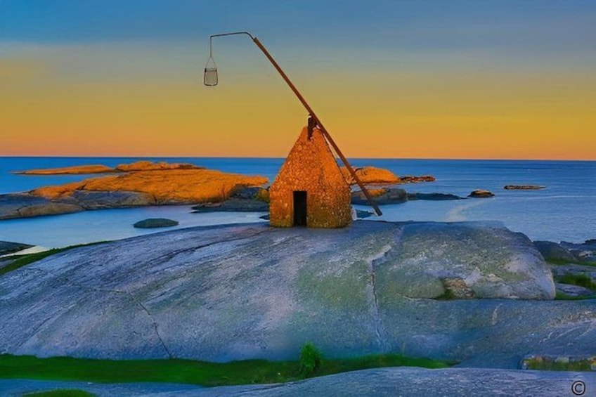A thatched-roof hut on a rocky outcrop with a fishing net and a light fixture. 1