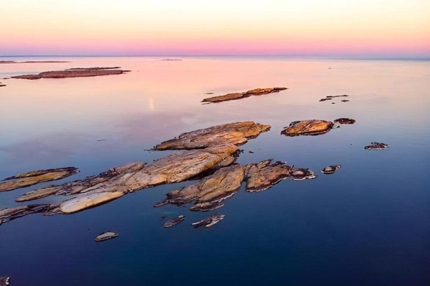 A coastal landscape with rocky formations and calm waters. 2