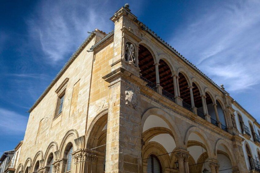 A historic building with arched windows and a clock tower. 2