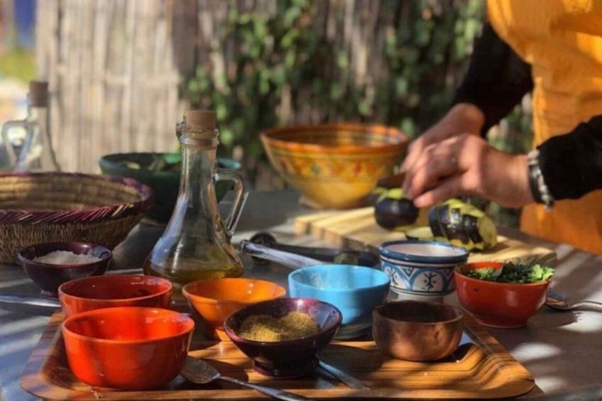 A table with various bowls and a bottle, likely for a cooking or food preparation activity. 1