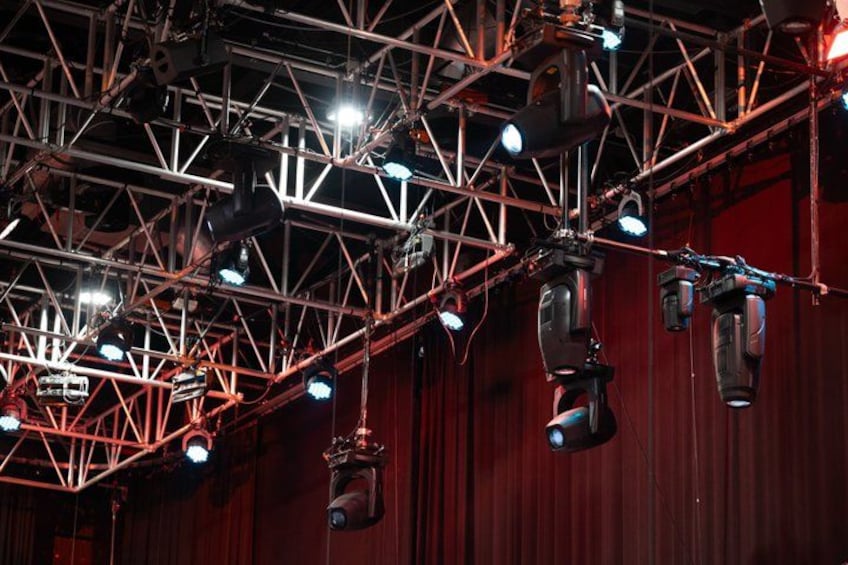 A stage with a truss structure and multiple spotlights. 4