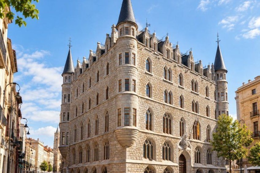 A historic building with multiple towers and arched windows. 4