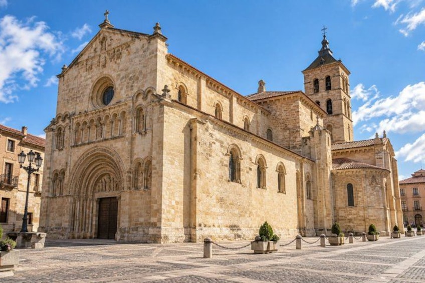 A historic stone building with a bell tower and arched windows. 5