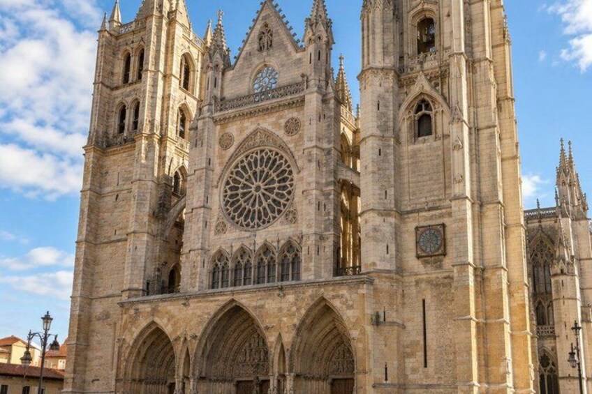 A large cathedral with a rose window, pointed arches, and a clock. 3