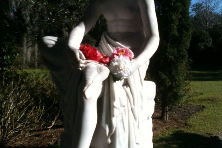 A statue with a bouquet of flowers. 5