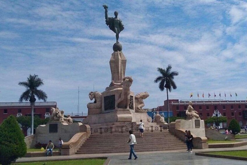 A monument with a central statue, surrounded by steps and palm trees. 5