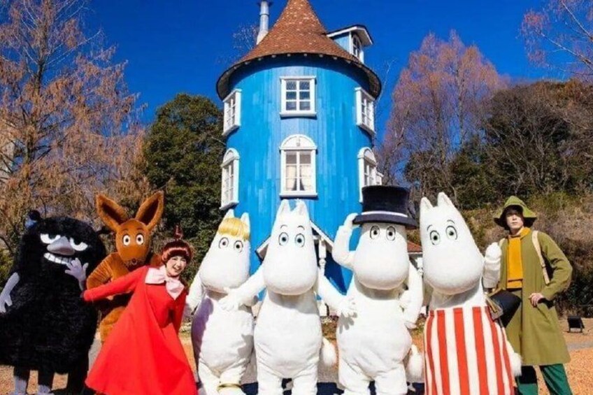A blue tower, white characters, and a person in a red dress. 1