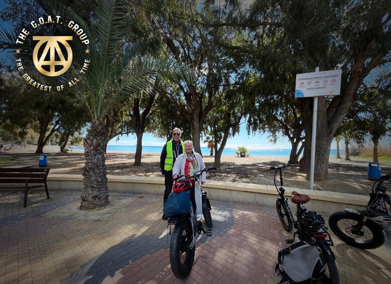 Two people on a beach with a sign prohibiting termination. 4