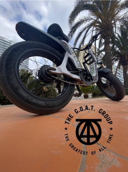 A motorcycle with a rear wheel, a chain, and a tire. 2