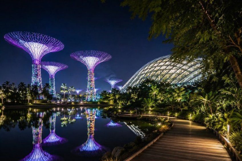 Illuminated structures, a water body, and a pathway. 5