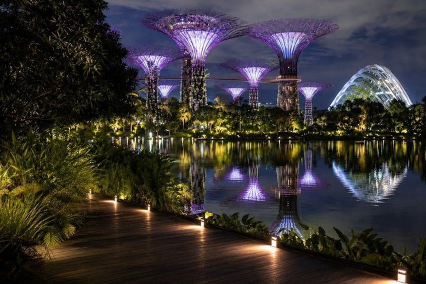 A nighttime view of a water body with illuminated structures and a pathway. 4