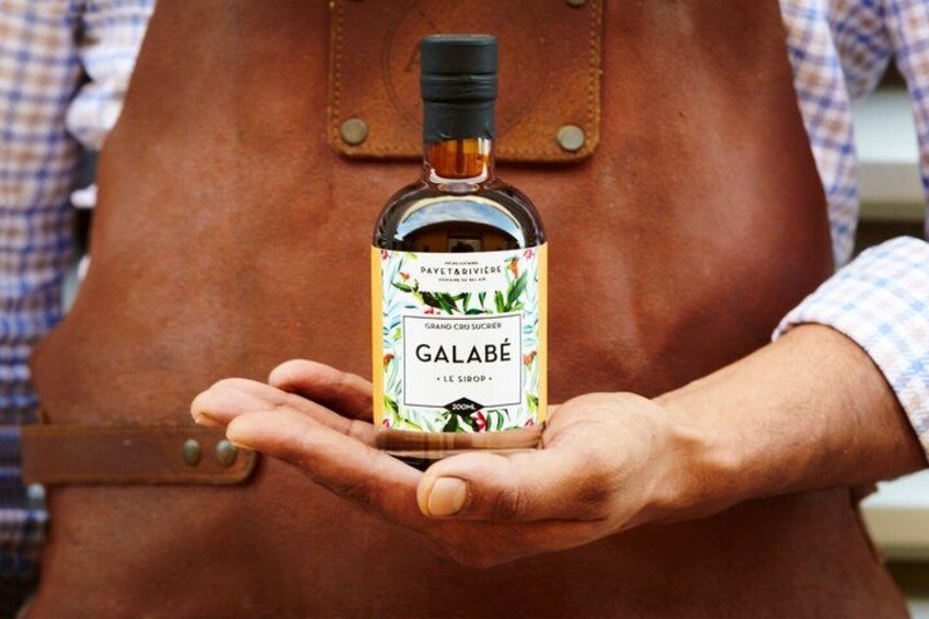 A person holding a bottle of Galabé. 1