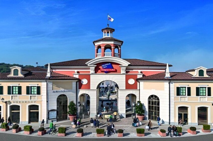 A historic building with a clock tower, arched windows, and a central entrance. 4