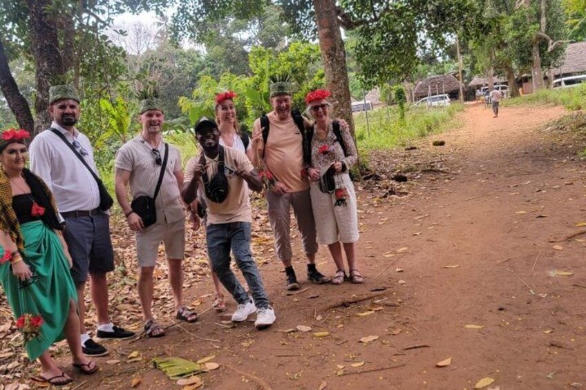 A group of people on a dirt path in a forested area. 2
