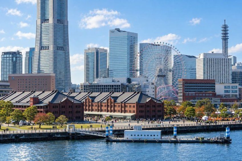 A city skyline with modern skyscrapers, a Ferris wheel, and a waterfront with a bridge. 1