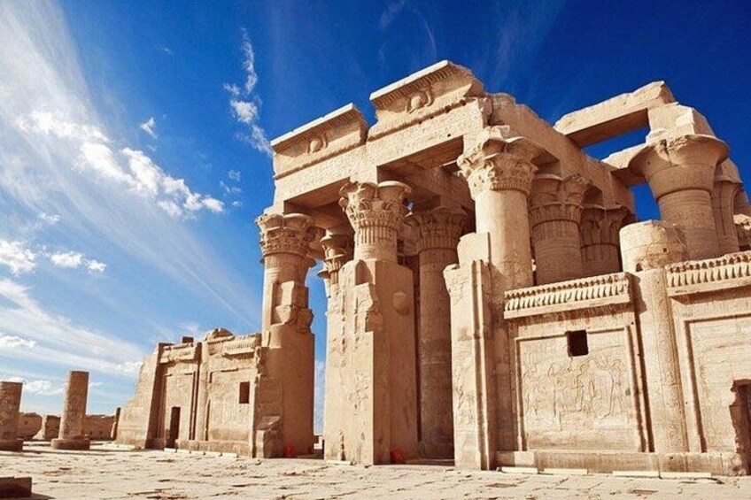 Ancient stone ruins with columns and arches under a clear sky. 1