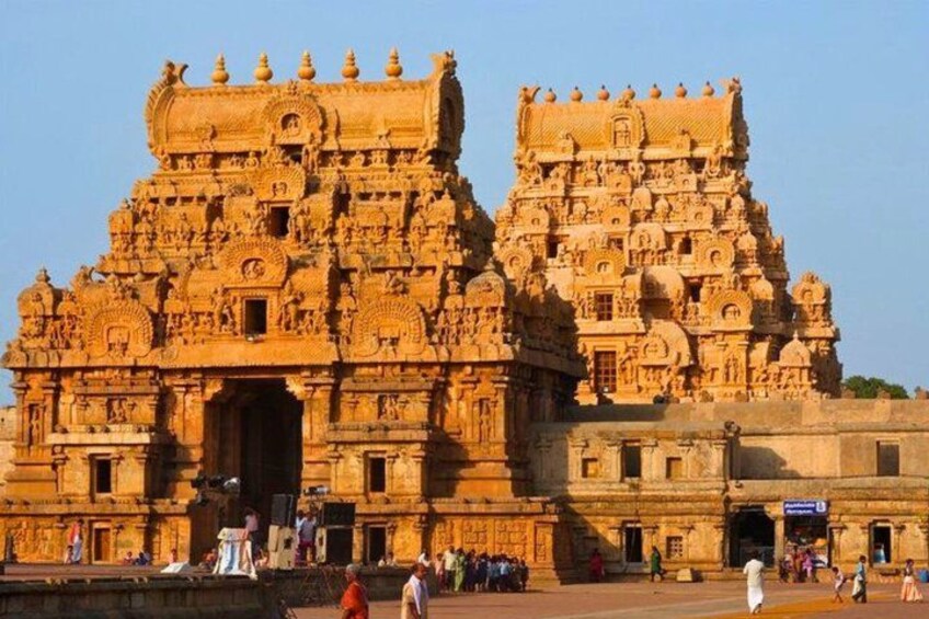 A large, intricately carved temple with multiple tiers and detailed sculptures. 3