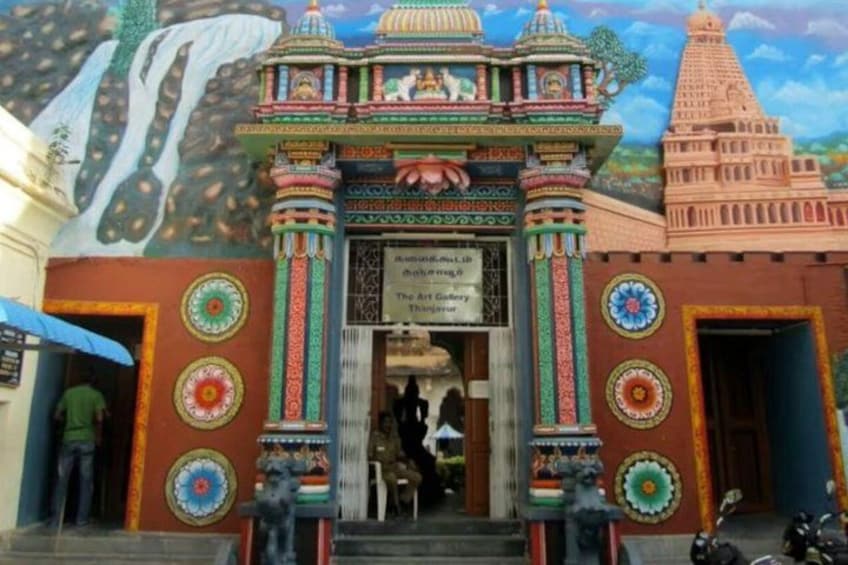 A colorful temple entrance with intricate designs and a sign for The Art Gallery Thanjavur. 1