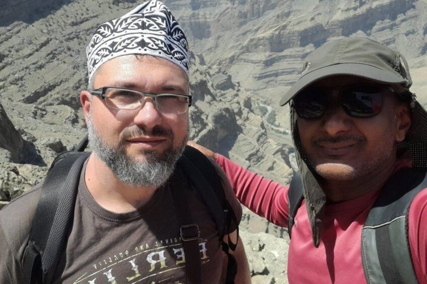 Two individuals in a mountainous landscape with rocky terrain. 3