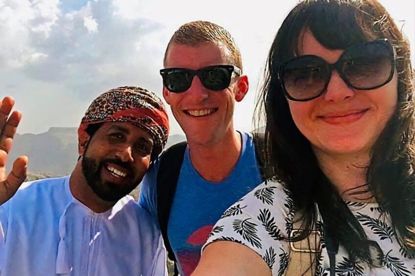 Three people taking a selfie with a mountainous landscape in the background. 5