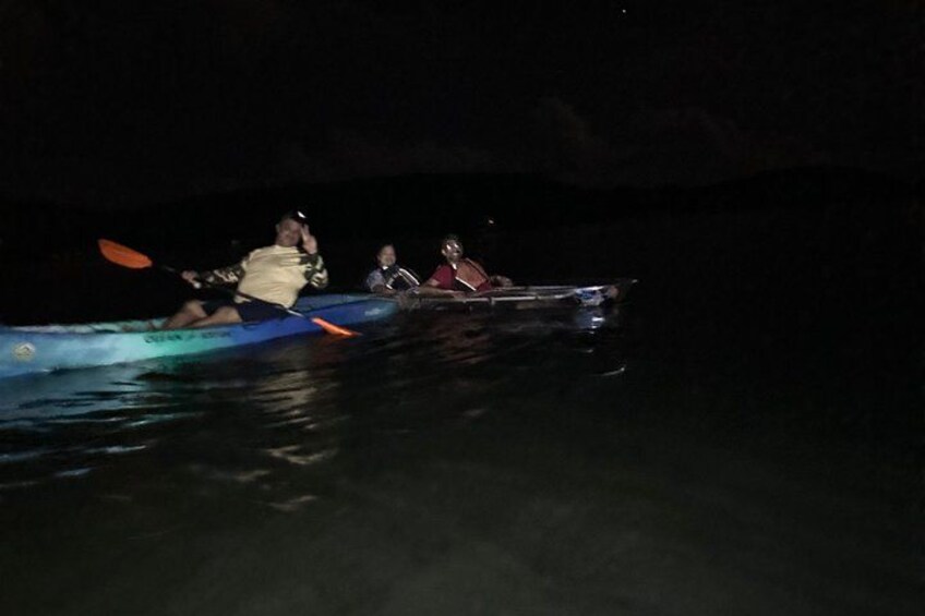 People kayaking at night. 3