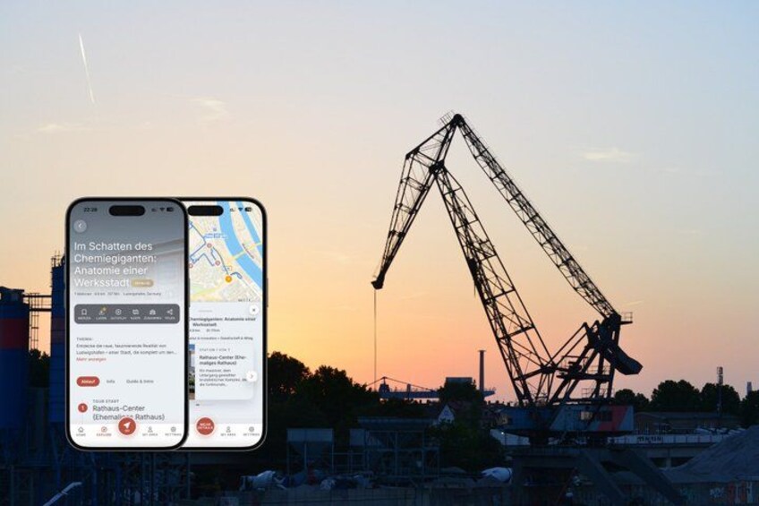 A smartphone displaying a map with a construction site and a large crane in the background. 1