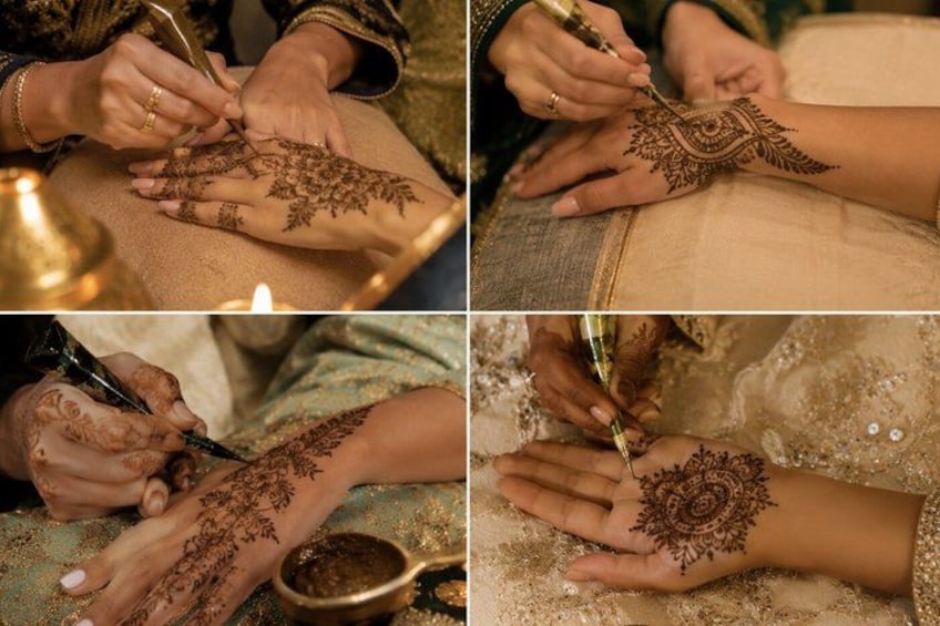 A person applying henna on another person's hands. 2
