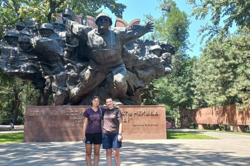 A large bronze statue of soldiers with a plaque in front. 4