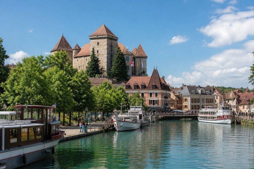 A historic castle, a river, and boats. 1
