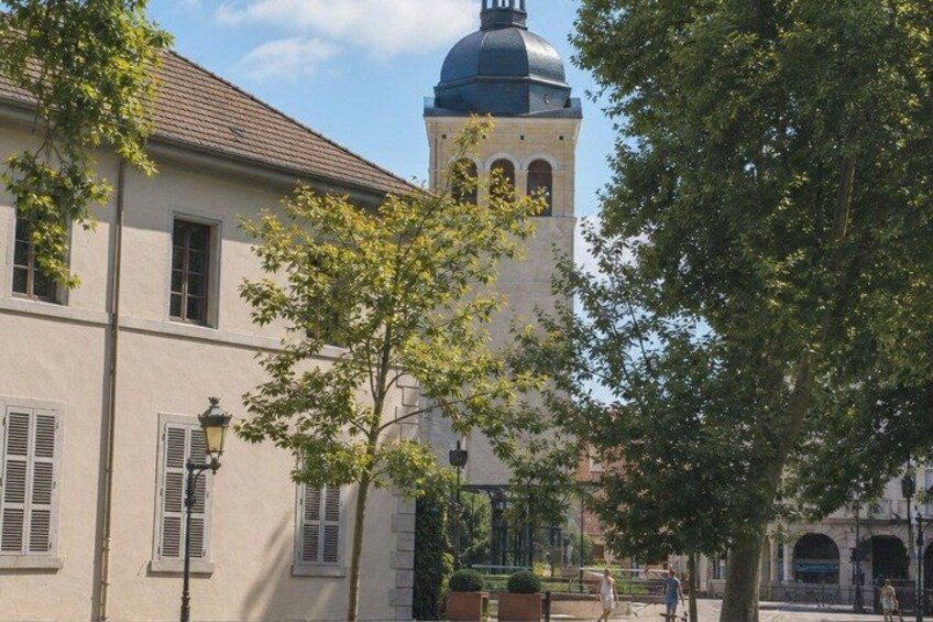 A building with a tower, trees, and a clear sky. 2