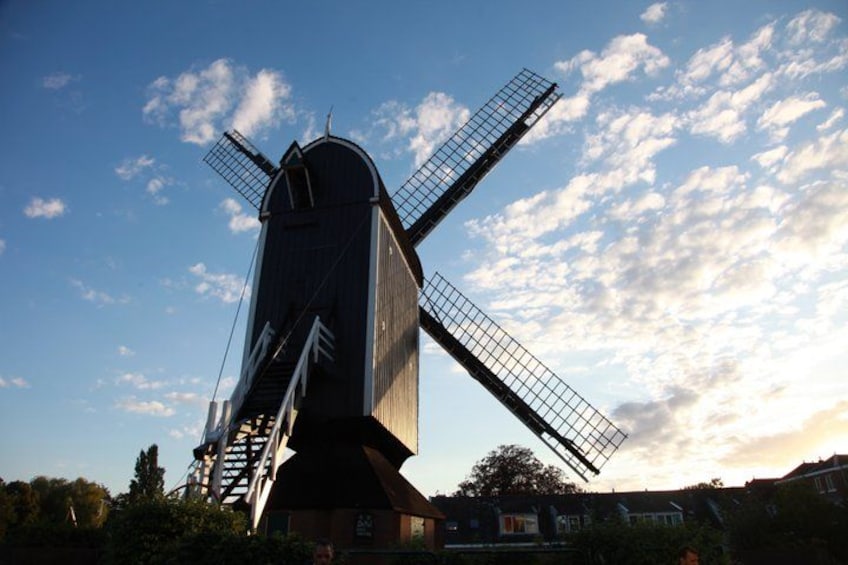 A windmill with a large sail and a staircase leading up to the top. 2