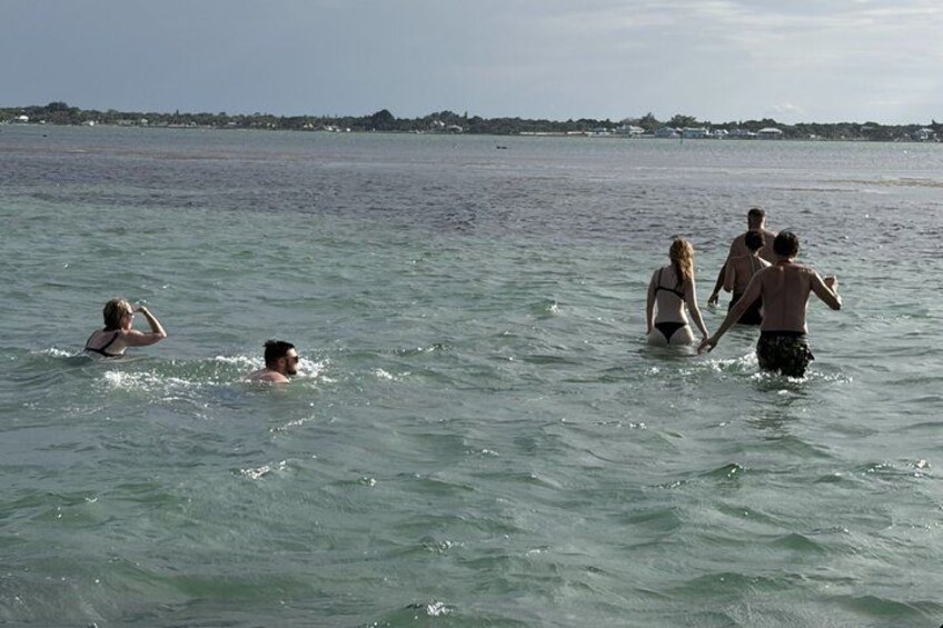 People swimming in a body of water with a distant shoreline. 4