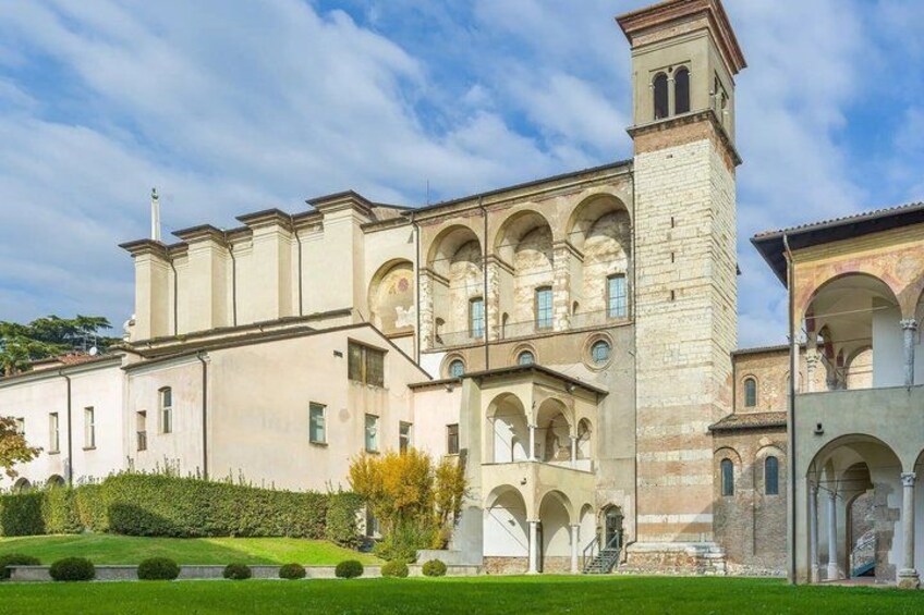 A historic building with arched windows and a tower. 2