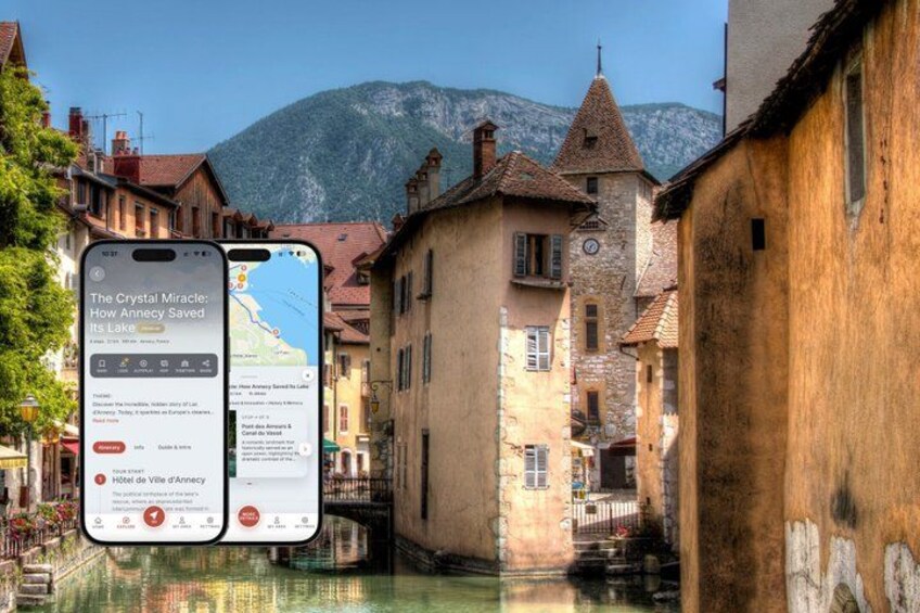 A smartphone displaying a travel app with a scenic view of a narrow waterway flanked by historic buildings and a mountain in the background. 1