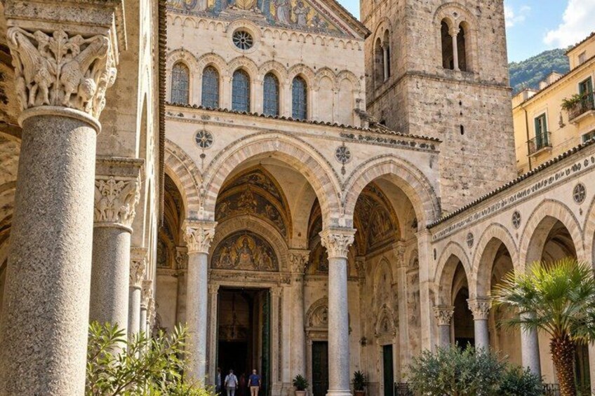 A historic building with arches, columns, and a tower. 4