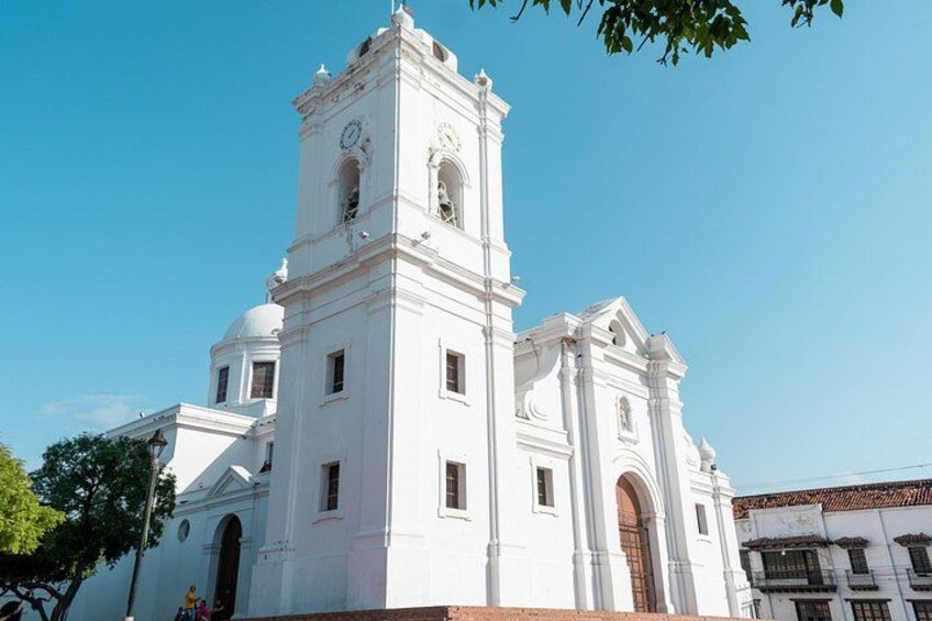 A white church with a bell tower and a dome. 4