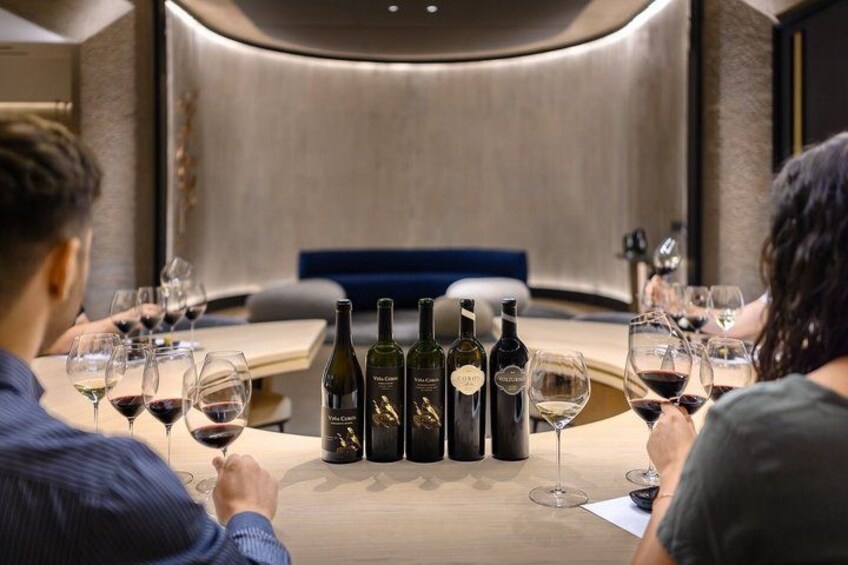 A round table with wine bottles and glasses in a modern interior. 4