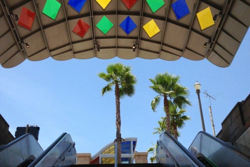 Escalators, palm trees, and a clear blue sky. 3