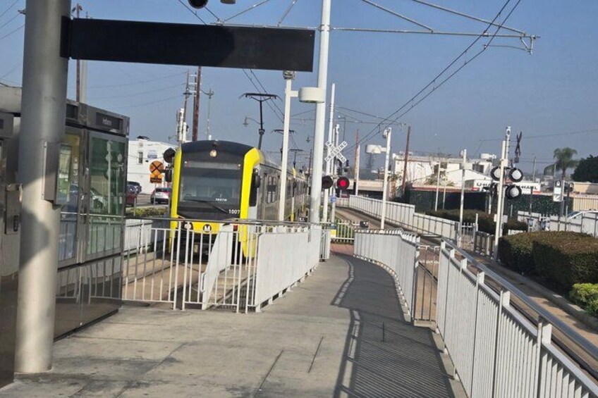 A train at a railway crossing with a pedestrian bridge. 2