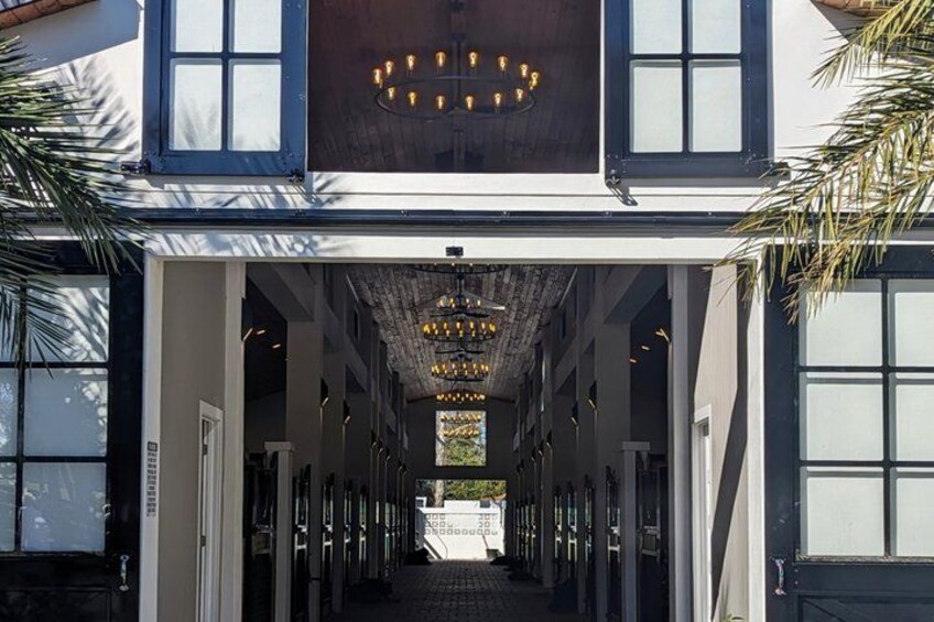 A building with a covered walkway, large windows, and a hanging light fixture. 4