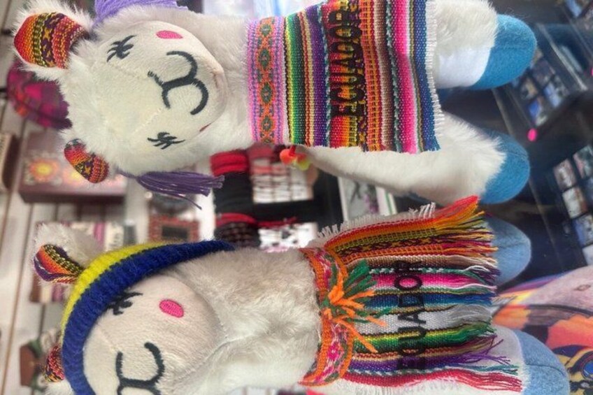 A llama with colorful woven blankets and a hat. 4