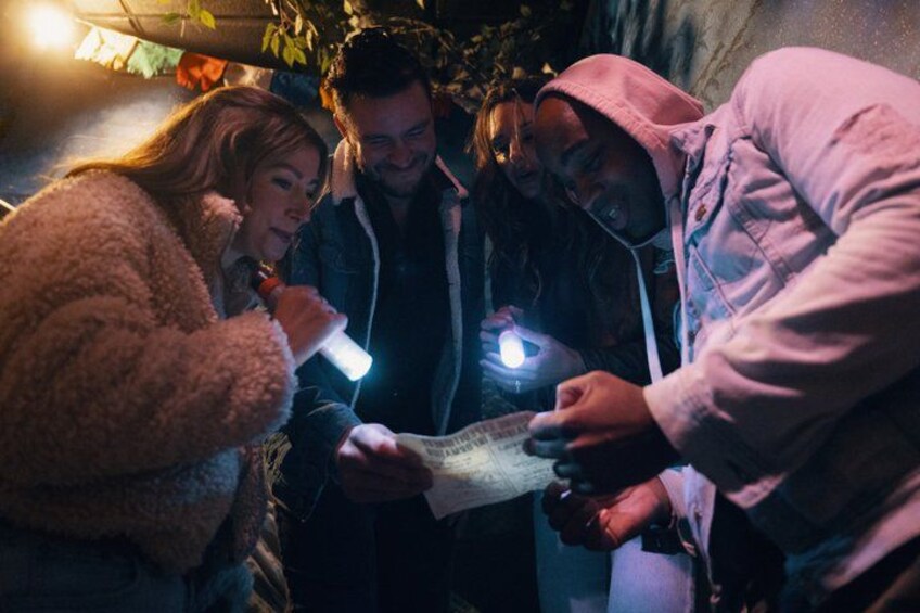 People examining a map in a dimly lit setting. 3