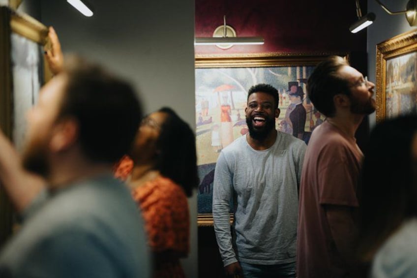 A group of people in an indoor setting with a painting on the wall. 4
