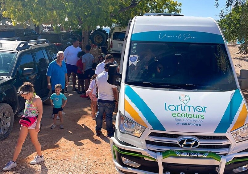 A group of people walking near a white van with 'Laramar ecotours' branding. 2