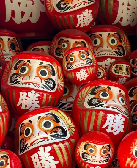 A collection of red and white painted dolls with gold accents. 5