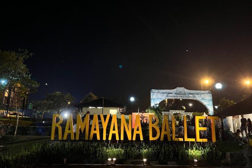 A nighttime view of the Ramayana Ballet sign with an illuminated archway in the background. 3