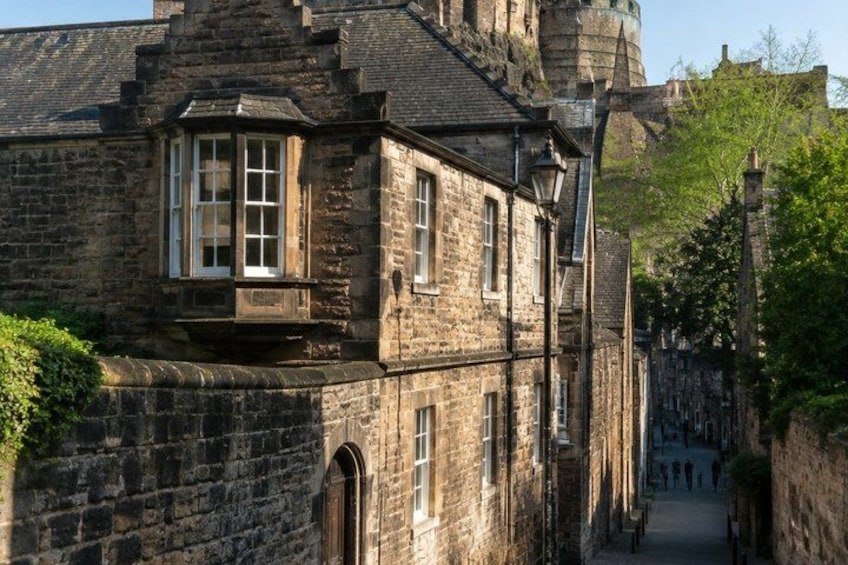 A historic stone building with arched windows and a turret. 4