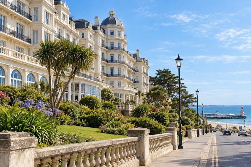 A seaside promenade with ornate buildings, a clear sky, and a distant ship. 2