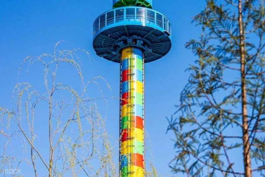 A tall tower with a colorful striped pattern and a blue top. 3